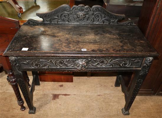 Late Victorian carved oak side table, fitted one long drawer
